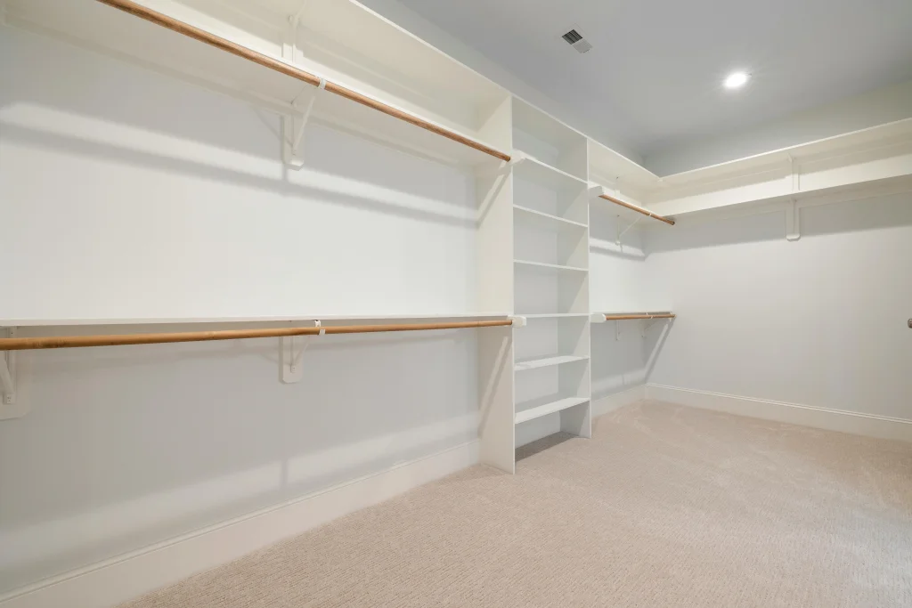 Spacious walk-in closet with custom hanging rods and shelves