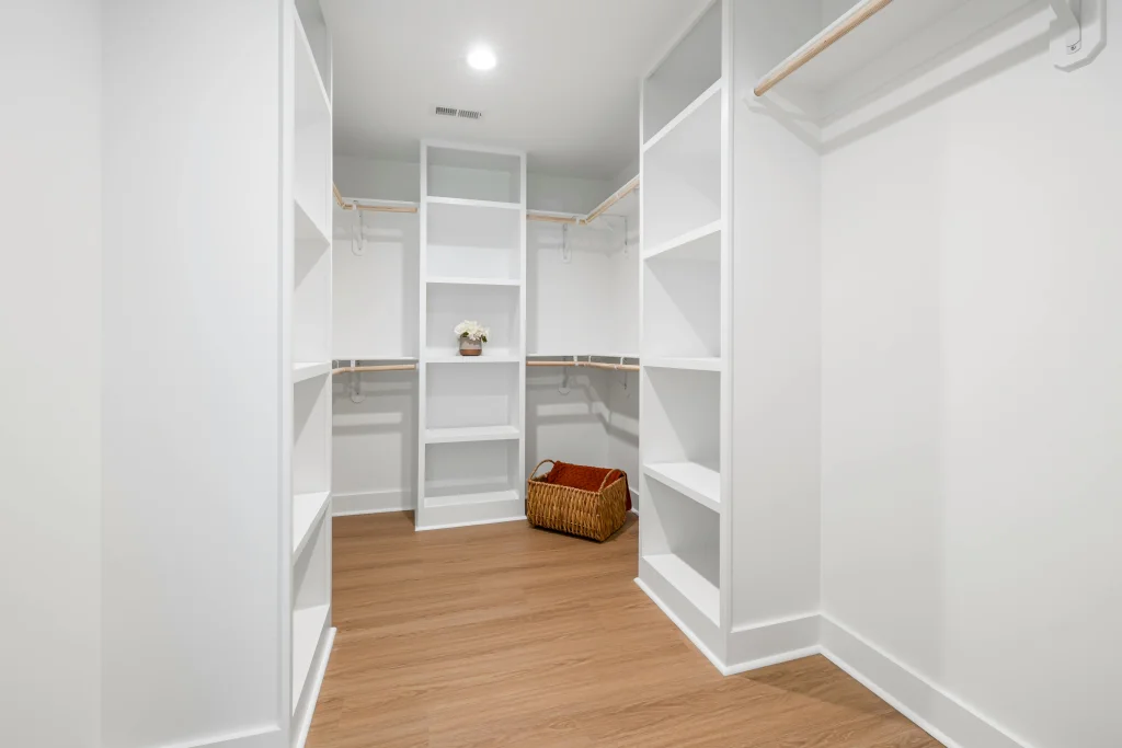Soft-lit walk-in closet with built-in shelving